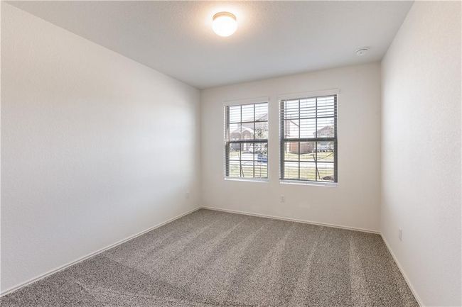 Carpeted spare room with a smoke detector and baseboards | Image 20