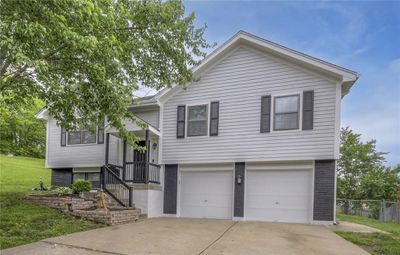 Split entry home with a garage and a front yard | Image 1