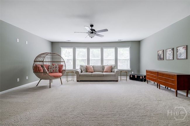 Huge media or lounging area at the top of the stairs between the bedrooms. | Image 24
