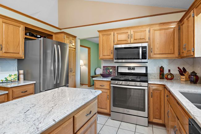 Newer granite countertops and stainless steel appliances. | Image 10