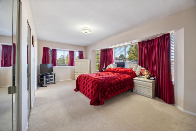 Bedroom featuring multiple windows, carpet, and baseboards | Image 25
