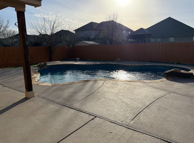 View of swimming pool featuring a fenced backyard, to enjoy all year. | Image 39