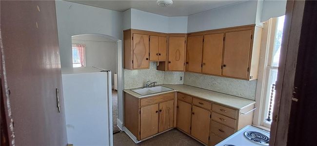 Kitchen featuring white appliances and light countertops | Image 4