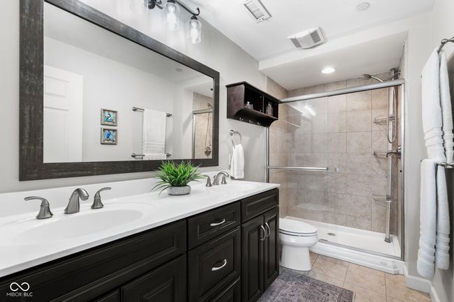 En suite bath features dual sinks & a tiled shower | Image 21
