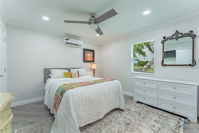 Bedroom featuring ceiling fan, ornamental molding, and a wall unit AC | Image 20