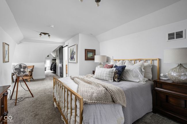 Carpeted bedroom featuring a spacious closet, and vaulted ceiling | Image 23
