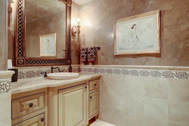 Third floor half bath has limestone counters onyx sink. | Image 37