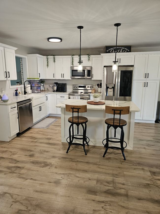 New kitchen with island, pantry and stainless-steel appliances. Check | Image 8