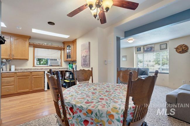 Dining space with ceiling fan, light wood-type flooring, and cooling unit | Image 11