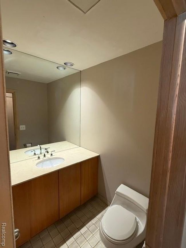 Half bathroom with light tile patterned flooring, vanity, and recessed lighting | Image 13