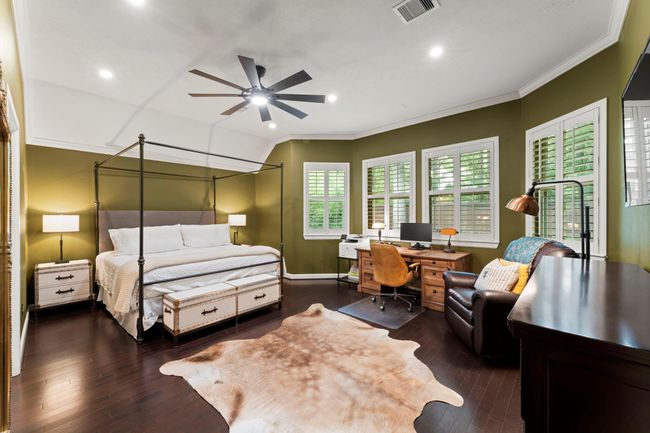 Large primary bedroom with bay windows overlooking the backyard. | Image 11