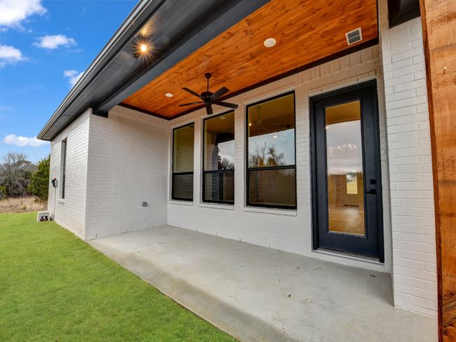 Entrance to property with ceiling fan and a yard | Image 22