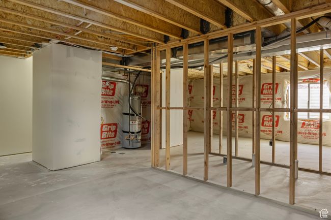Unfinished basement featuring water heater | Image 27