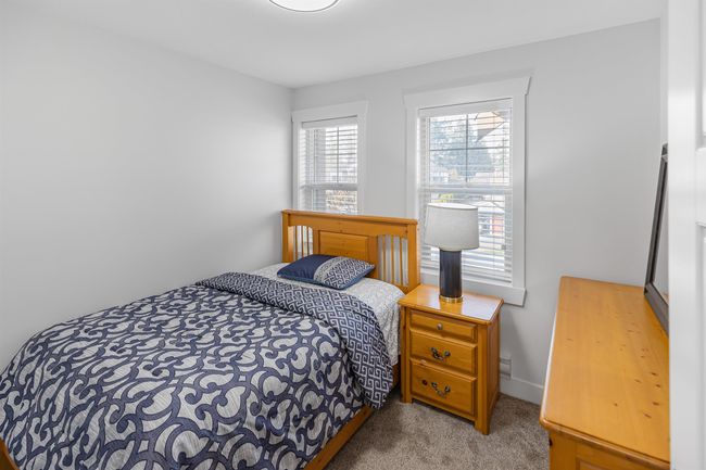 Carpeted bedroom with multiple windows | Image 15