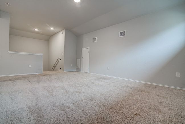 Carpeted spare room with recessed lighting, visible vents, baseboards, and lofted ceiling | Image 22