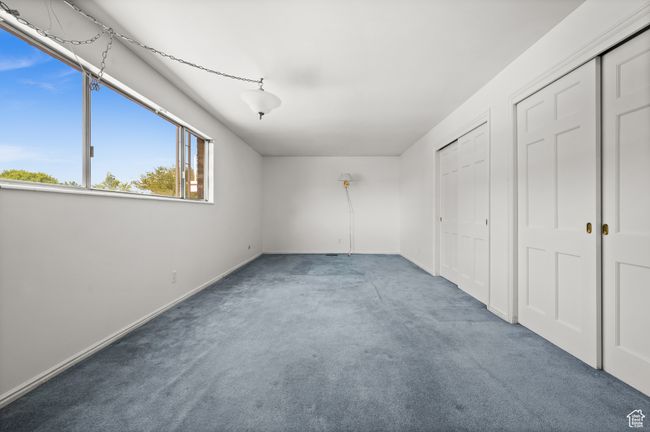 Unfurnished bedroom featuring carpet, baseboards, and two closets | Image 20