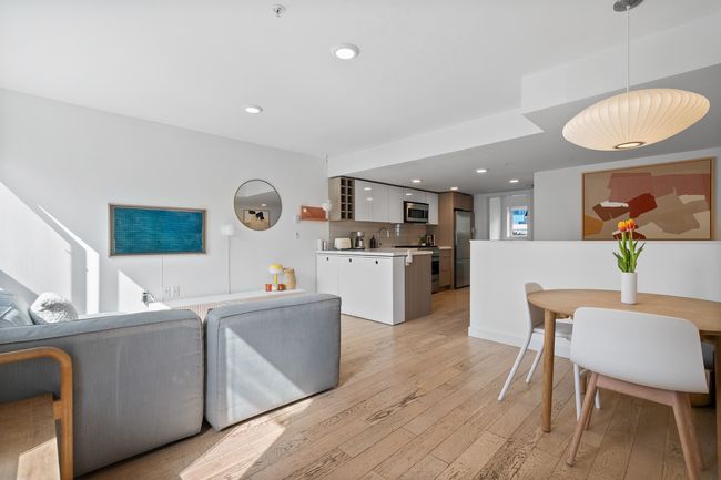 Living area with light wood-style flooring and recessed lighting | Image 8