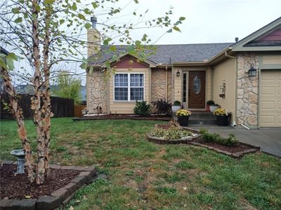 Single story home with a front lawn and a garage | Image 3