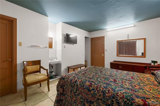 Bedroom featuring light tile patterned floors and a sink | Image 10