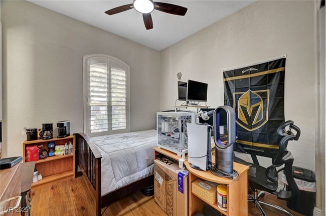Bedroom with wood finished floors and a ceiling fan | Image 42