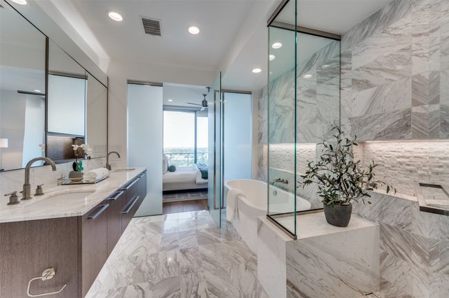 Ensuite bathroom featuring marble tiled floors, recessed lighting, double vanity, and a soaking tub | Image 12