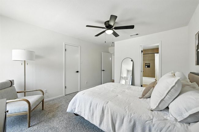 Bedroom with carpet flooring, ceiling fan, and ensuite bathroom | Image 28