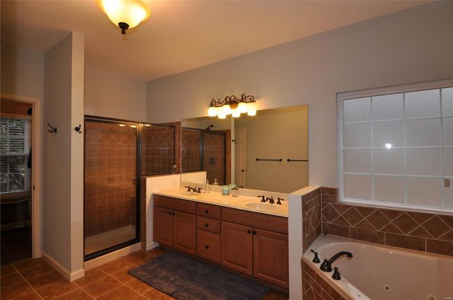 Double vanities, large corner tub & separate shower & large walk-in closet. | Image 20