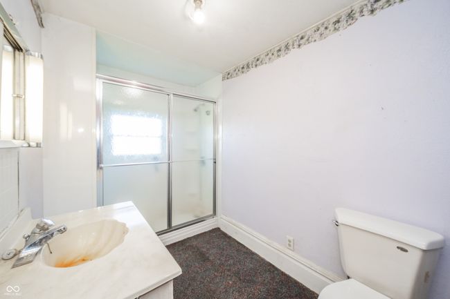 bathroom with toilet, a shower stall, vanity, and baseboards | Image 12