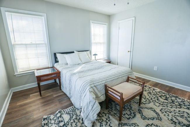Bedroom with a textured ceiling, wood finished floors, and baseboards | Image 21