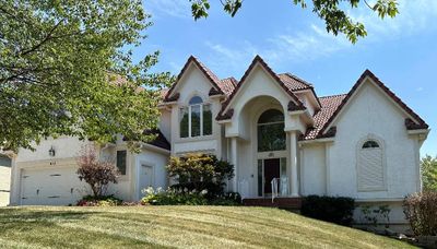 View of front of house with a garage and a front yard | Image 1