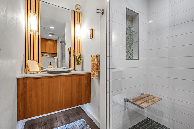 Bathroom featuring vanity, wood finished floors, and tiled shower | Image 24