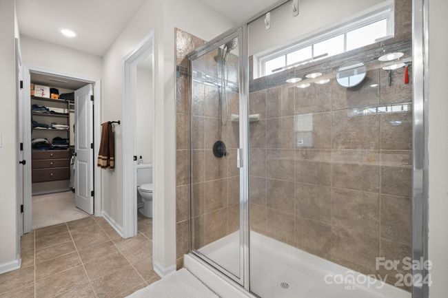 Beautiful large shower. Walk-in closet to the left and the private toilet room to the right. | Image 31