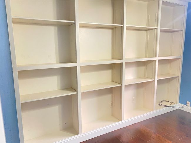 View of library shelves in 3rd bedroom | Image 35