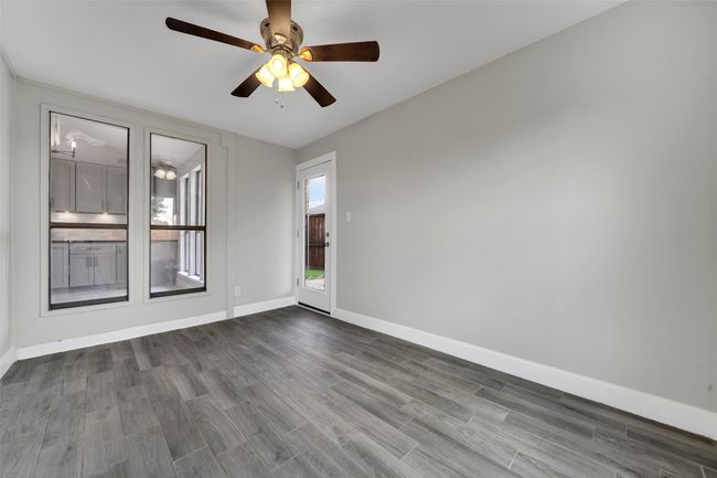 Unfurnished room with dark wood-type flooring and a ceiling fan | Image 23