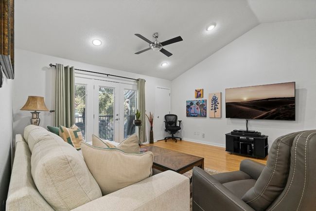 Living room with ceiling fan, wood finished floors, recessed lighting, baseboards, and high vaulted ceiling | Image 5
