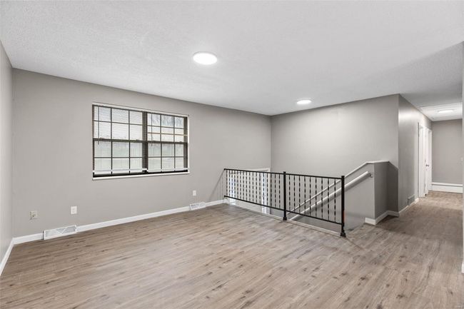 Empty room featuring wood finished floors, baseboards, and visible vents | Image 5