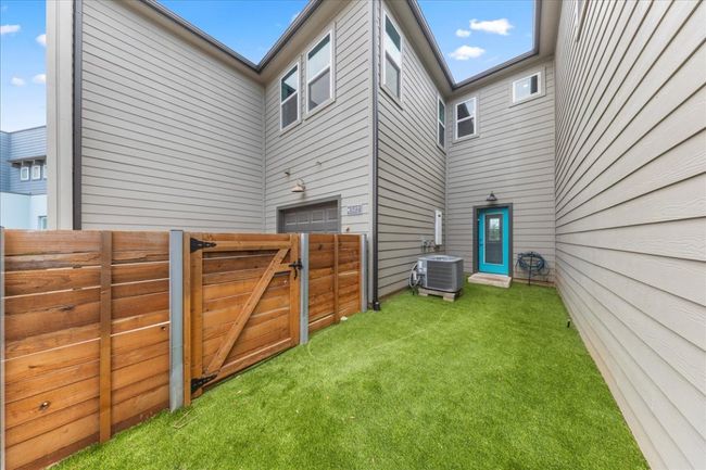 View of yard with central air condition unit, a gate, and a garage | Image 34