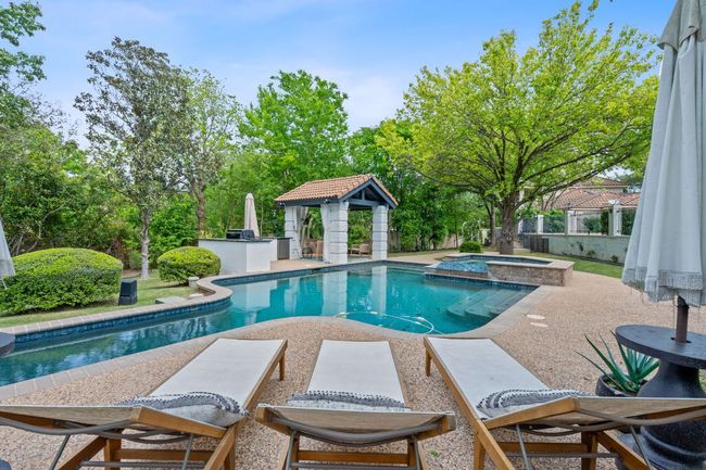 Sparkling pool and hot tub featuring a cabana and outdoor living area | Image 32