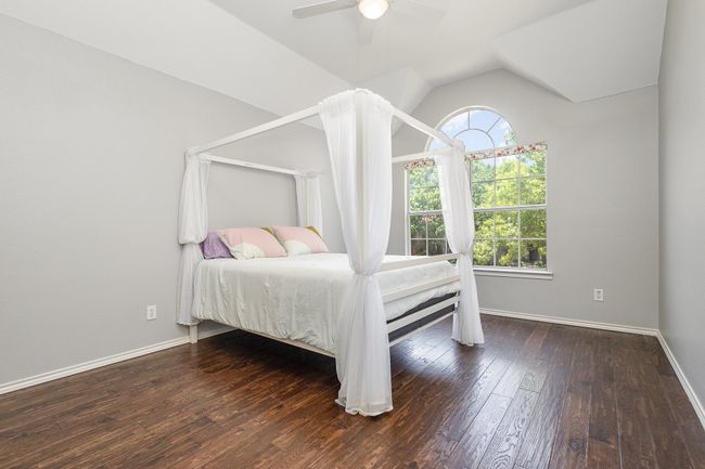 Bedroom with hardwood floors, vaulted ceiling, and ceiling fan, jack & jill bath | Image 21