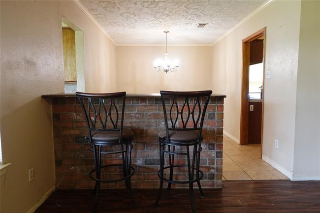 Cozy bar area adjacent to the formal dining room, offering a seamless flow into the living space. Perfect for entertaining. | Image 15