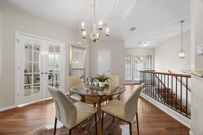 Dining room with vinyl wood floors, lots of natural light, and chandelier | Image 17