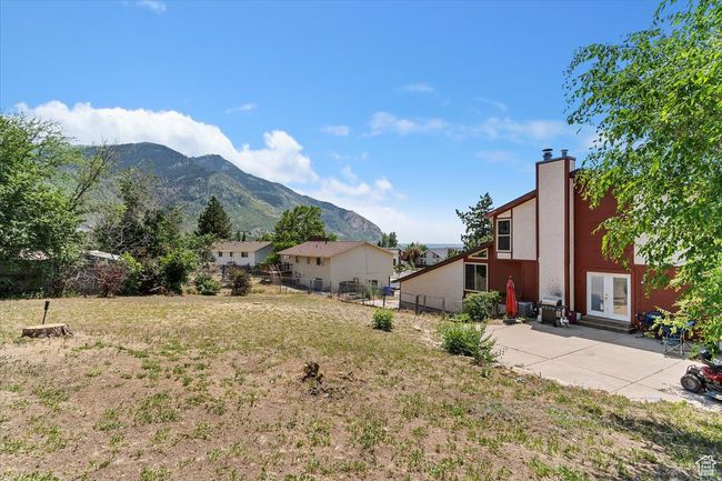 View of yard featuring a mountain view, french doors, and a patio | Image 33