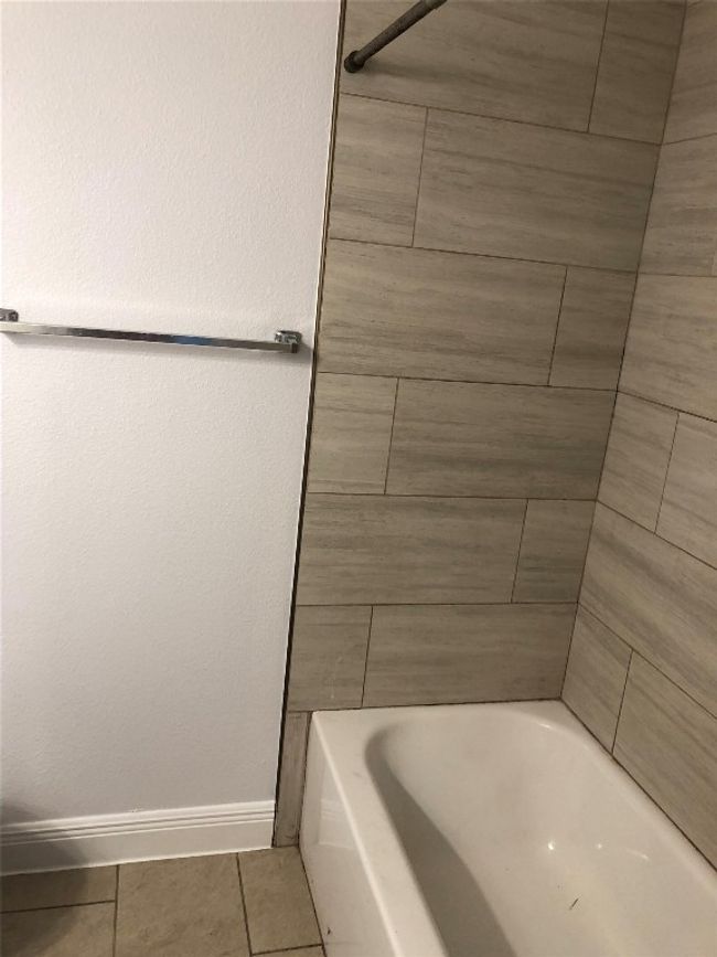Bathroom with a bath, tile patterned flooring, and a shower | Image 17