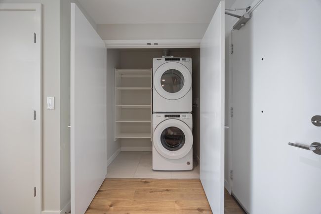 Washroom featuring tile patterned floors, stacked washer and clothes dryer, and laundry area | Image 17
