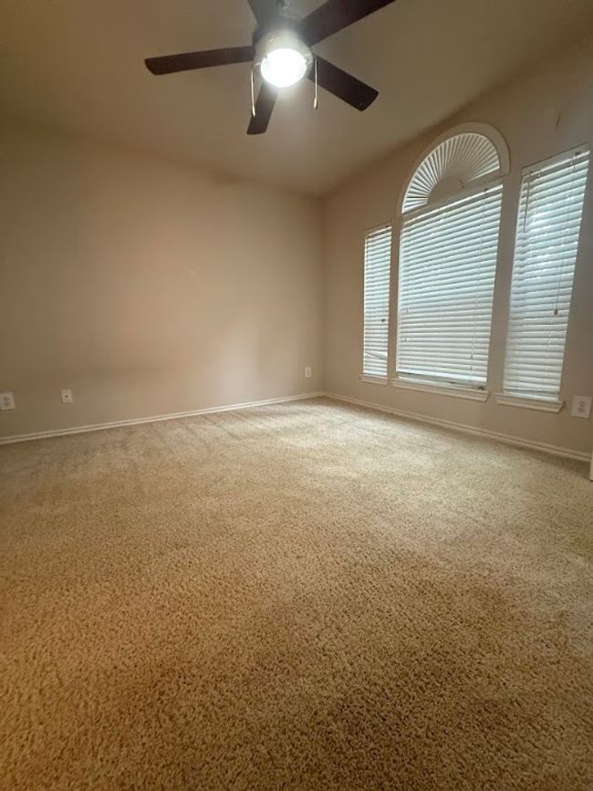 Carpeted spare room featuring a ceiling fan and baseboards | Image 22
