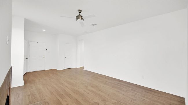 Unfurnished room with light wood finished floors, visible vents, and a ceiling fan | Image 10