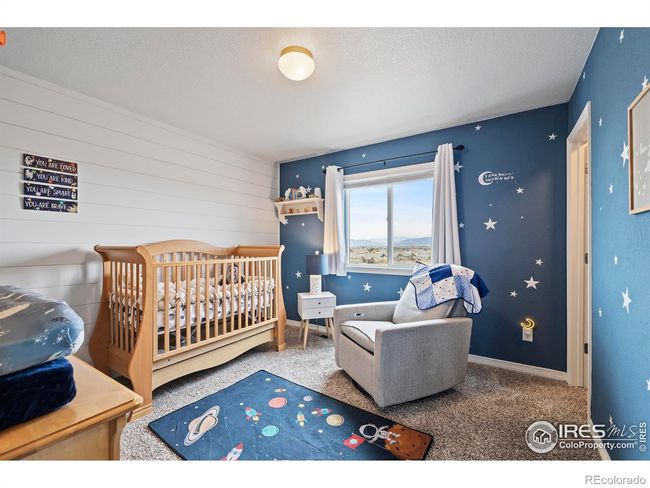 Smaller of the 3 upstairs bedrooms has shiplap wall decor | Image 19