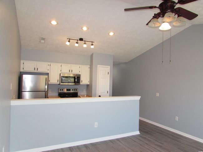 View from the living room towards the kitchen. | Image 32