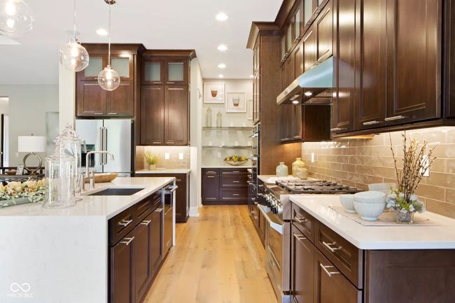 The open kitchen offers plenty of space to cook and entertain, complete with a walk-in pantry for added convenience. | Image 6