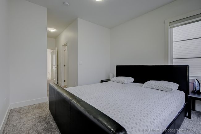 Bedroom featuring light colored carpet and baseboards | Image 8